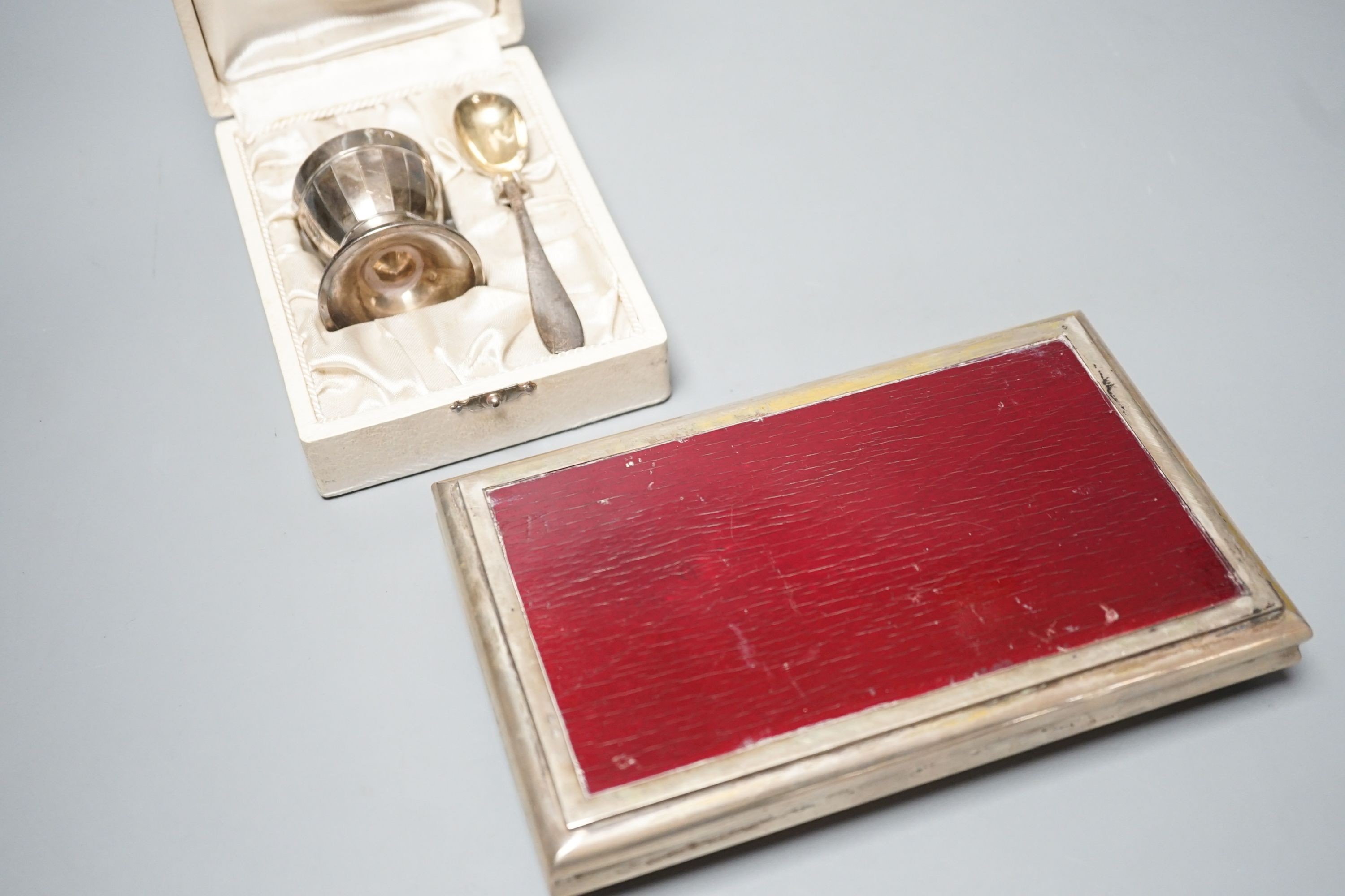 A modern Italian 800 standard white metal mounted cigarette box, 18.5cm and a cased French white metal egg cup and spoon.